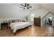 This bedroom features a ceiling fan, wood floors, and a sloped ceiling at 115 Woodward Way, Iron Station, NC 28080