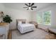 Bright bedroom with a plush rug, crib, and windows providing natural light, creating a peaceful and inviting space at 115 Woodward Way, Iron Station, NC 28080