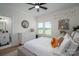 This bedroom features a ceiling fan, a large window with a grassy lawn view, and a white dresser at 115 Woodward Way, Iron Station, NC 28080