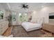 Tranquil bedroom featuring tray ceilings, large windows, and plush furnishings at 115 Woodward Way, Iron Station, NC 28080