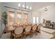 Elegant dining room with large windows, natural light, and modern lighting fixture at 115 Woodward Way, Iron Station, NC 28080