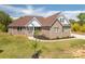 Charming brick home featuring a well-manicured lawn and inviting front porch at 115 Woodward Way, Iron Station, NC 28080