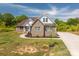 A well-maintained brick home with a lush lawn and a long driveway at 115 Woodward Way, Iron Station, NC 28080