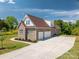 Spacious detached garage with a long driveway and lush landscaping at 115 Woodward Way, Iron Station, NC 28080