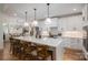 Bright kitchen features a spacious island with seating and sleek, modern appliances at 115 Woodward Way, Iron Station, NC 28080