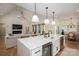 Bright, open kitchen with a large island, modern appliances, and pendant lighting at 115 Woodward Way, Iron Station, NC 28080