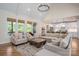 Cozy living room features a vaulted ceiling, large windows, and hardwood floors at 115 Woodward Way, Iron Station, NC 28080