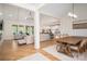 Open concept living room with a dining area, hardwood floors, and vaulted ceilings at 115 Woodward Way, Iron Station, NC 28080