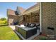 Spacious patio with comfortable seating, perfect for outdoor entertaining and relaxation with brick columns and stairs at 115 Woodward Way, Iron Station, NC 28080