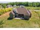 Spacious brick home featuring an expansive backyard and an inviting outdoor patio seating area at 115 Woodward Way, Iron Station, NC 28080