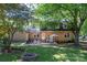 Relaxing backyard features mature trees, a fire pit, and a patio area for entertaining at 1324 Princeton Ave, Gastonia, NC 28054