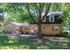 Backyard featuring a patio with outdoor seating, a brick facade, and mature trees at 1324 Princeton Ave, Gastonia, NC 28054