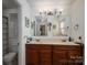 Bathroom featuring a double sink vanity and a large mirror with decorative lighting at 1324 Princeton Ave, Gastonia, NC 28054