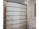 Bathroom featuring a shower with white and blue striped curtain and a window at 1324 Princeton Ave, Gastonia, NC 28054