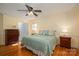 Spacious bedroom with hardwood floors, a ceiling fan, and a door leading to the bathroom at 1324 Princeton Ave, Gastonia, NC 28054