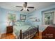 Comfortable bedroom with a decorative quilt, ceiling fan, and natural light from two windows at 1324 Princeton Ave, Gastonia, NC 28054
