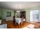 Sunlit dining room featuring hardwood floors and a classic china cabinet at 1324 Princeton Ave, Gastonia, NC 28054