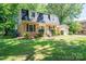 Inviting brick home with a garage, dormer windows, and manicured landscaping at 1324 Princeton Ave, Gastonia, NC 28054