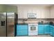 Efficient kitchen featuring stainless steel refrigerator, white cabinets, and colorful backsplash at 1324 Princeton Ave, Gastonia, NC 28054