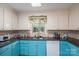 Bright kitchen with blue cabinets, stainless steel sink, and granite countertops at 1324 Princeton Ave, Gastonia, NC 28054