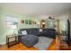 Inviting living room with large gray sectional couch, hardwood floors, and natural light at 1324 Princeton Ave, Gastonia, NC 28054