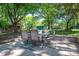 Inviting patio with stone pavers is perfect for outdoor dining under a canopy of mature shade trees at 1324 Princeton Ave, Gastonia, NC 28054