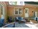 Outdoor patio with comfortable seating, brick facade, and view of the backyard at 1324 Princeton Ave, Gastonia, NC 28054