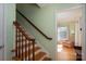 Staircase with wooden railings, leading up to the next floor and view of the living room at 1324 Princeton Ave, Gastonia, NC 28054