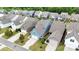 Charming homes line the street with attached garages and beautifully maintained lawns, creating inviting curb appeal at 13332 Caite Ridge Rd, Davidson, NC 28036