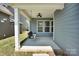 Relaxing back porch features a porch swing and ceiling fan for outdoor enjoyment at 13332 Caite Ridge Rd, Davidson, NC 28036
