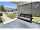 Inviting back porch with a comfortable swing, perfect for relaxing outdoors at 13332 Caite Ridge Rd, Davidson, NC 28036