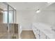 Bright bathroom features a glass enclosed shower, double sinks, and tile floors at 13332 Caite Ridge Rd, Davidson, NC 28036