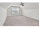 Spacious bedroom with an angled ceiling, carpet, and a window with natural light at 13332 Caite Ridge Rd, Davidson, NC 28036