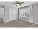Bright bedroom featuring a double closet and a large window providing abundant natural light at 13332 Caite Ridge Rd, Davidson, NC 28036