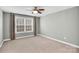 Spacious bedroom illuminated by natural light, featuring plush carpet and a ceiling fan at 13332 Caite Ridge Rd, Davidson, NC 28036