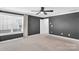 Spacious bedroom featuring a window, dark wall paint, and a ceiling fan at 13332 Caite Ridge Rd, Davidson, NC 28036