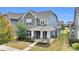 Attractive two-story home showcasing stone details, a covered porch, and a well-maintained landscape at 13332 Caite Ridge Rd, Davidson, NC 28036