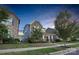 Beautiful home featuring stone accents, welcoming front porch, and lovely landscaping at 13332 Caite Ridge Rd, Davidson, NC 28036