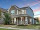 Charming two-story home boasting stone accents, inviting front porch, and professional landscaping at 13332 Caite Ridge Rd, Davidson, NC 28036