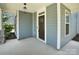 Welcoming front porch showcasing stone accents, painted siding, and a stylish front door at 13332 Caite Ridge Rd, Davidson, NC 28036