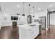 Kitchen features a center island, stainless steel appliances, pendant lights, and dark hardwood floors at 13332 Caite Ridge Rd, Davidson, NC 28036