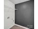 Unfinished laundry room featuring hookups, shelving, and a modern, grey accent wall at 13332 Caite Ridge Rd, Davidson, NC 28036