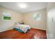 Bright bedroom features hardwood floors, two windows and neutral walls at 137 Burton Hills Cir, Gastonia, NC 28054