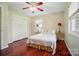 Bedroom featuring hardwood floors, two windows, closet and ceiling fan at 137 Burton Hills Cir, Gastonia, NC 28054