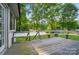 A spacious wooden deck offers views of the surrounding yard and lush greenery beyond at 137 Burton Hills Cir, Gastonia, NC 28054