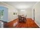 Spacious dining room featuring hardwood floors, a chandelier, and natural light at 137 Burton Hills Cir, Gastonia, NC 28054
