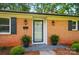 Inviting front entrance with brick facade, decorative lanterns, and slate tile entryway at 137 Burton Hills Cir, Gastonia, NC 28054