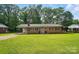 Charming brick home featuring a well-maintained lawn and covered carport at 137 Burton Hills Cir, Gastonia, NC 28054