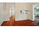 View of the hallway to the kitchen and living room featuring hardwood floors and natural light at 137 Burton Hills Cir, Gastonia, NC 28054