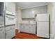 Cozy kitchen with grey cabinets, a built-in oven and refrigerator and a side entrance at 137 Burton Hills Cir, Gastonia, NC 28054